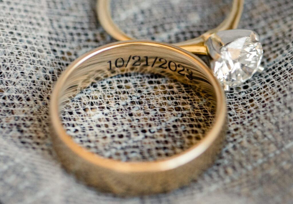 Close-up of wedding rings with a date engraving on a veil